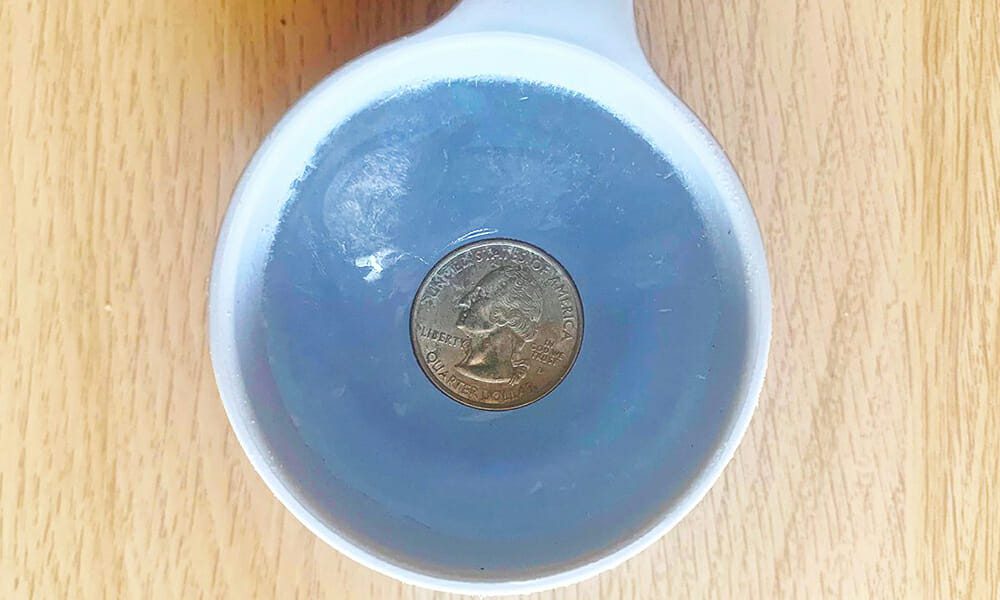 Put a quarter on a cup of ice 001